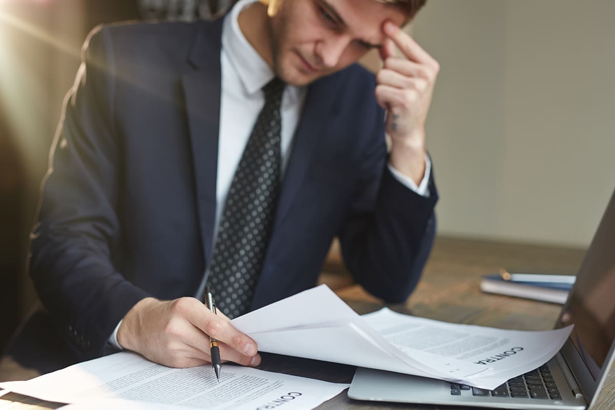 Workers comp claim denied in North Carolina: a worker reading the denial paperwork