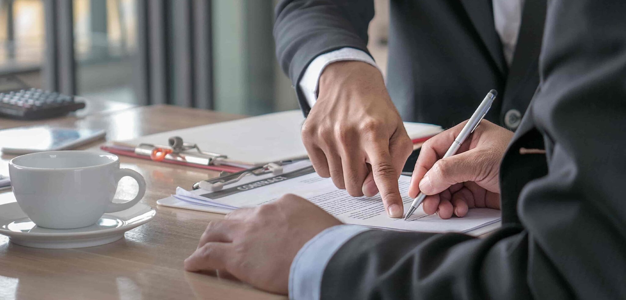 North Carolina settlement calculator figures reviewed on paper beside a calculator
