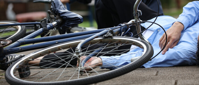 A biker falls off his bake in a bicycle accident