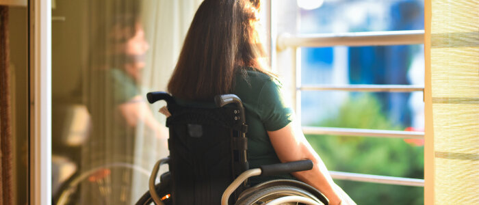 A woman in a wheelchair looking outside