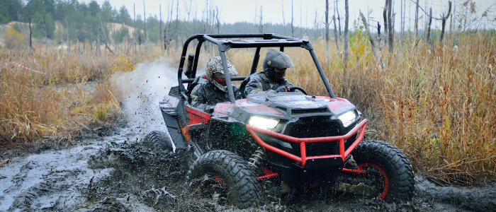 An atv goes through the mud