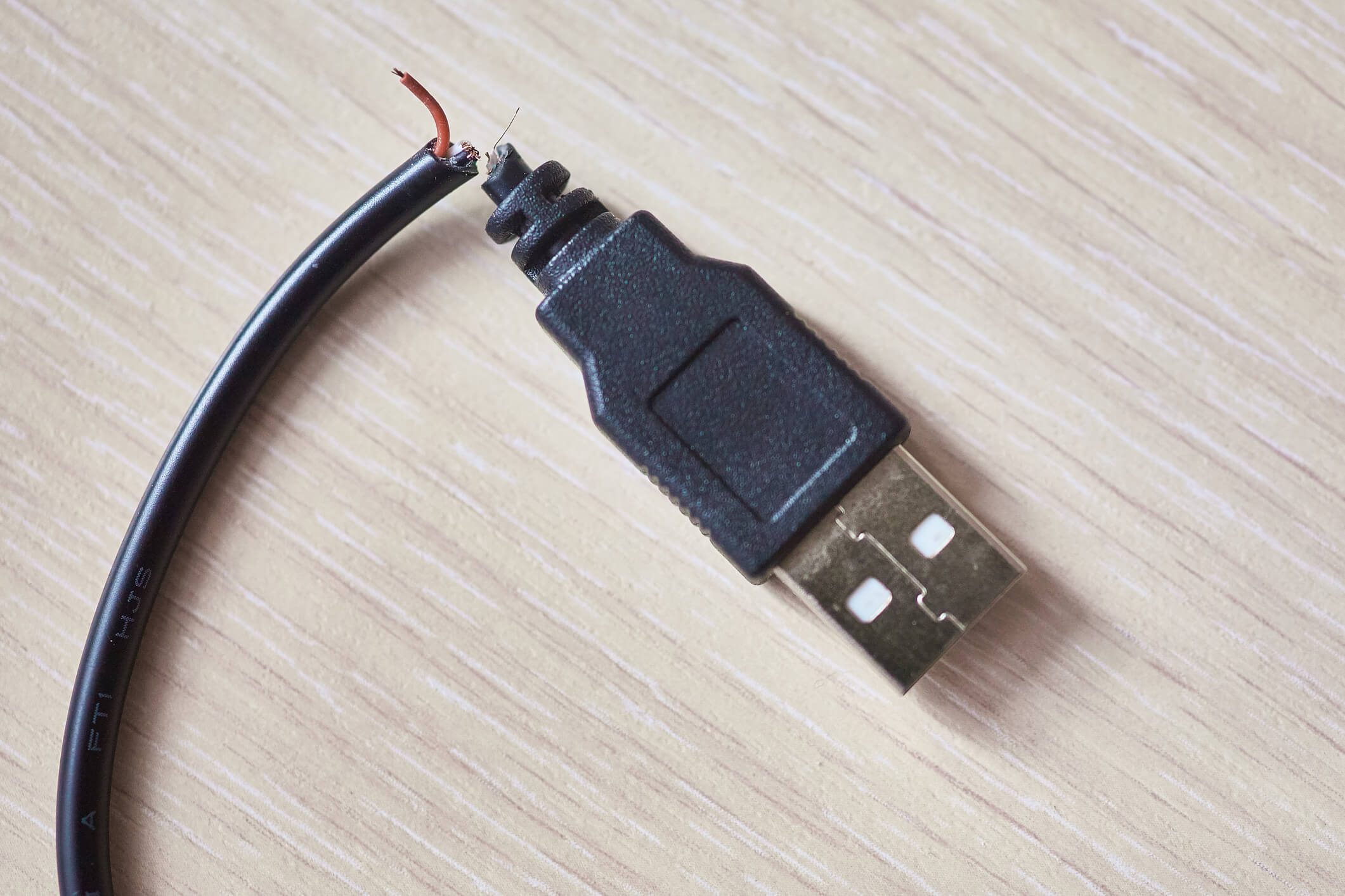 Broken usb cable on wooden table