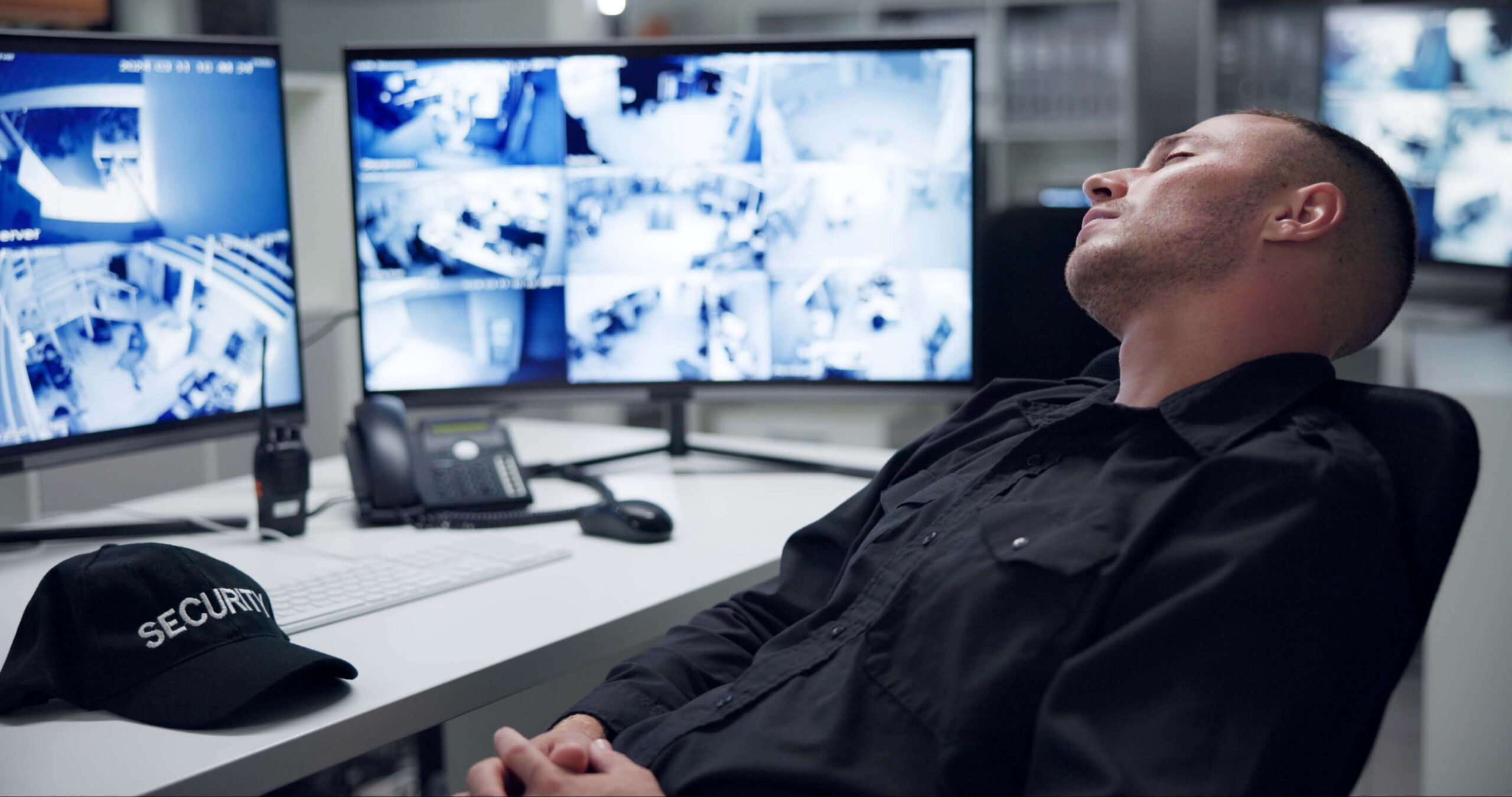 Security guard, computer screen and tired by cctv monitor for protection, data center or building safety. Inspection, control room with footage and video surveillance agency, technology and sleeping