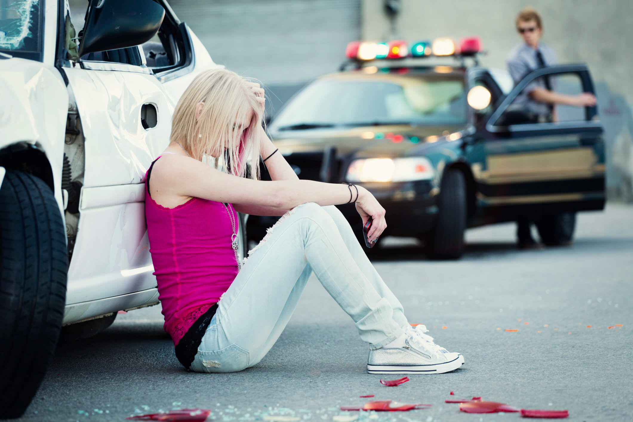A police officer at a car accident scene.