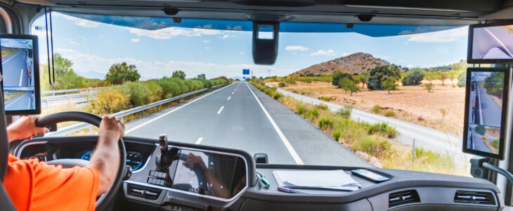 View of the interior of a state-of-the-art truck as it travels along the highway, where the driver receives all the information through the screens.