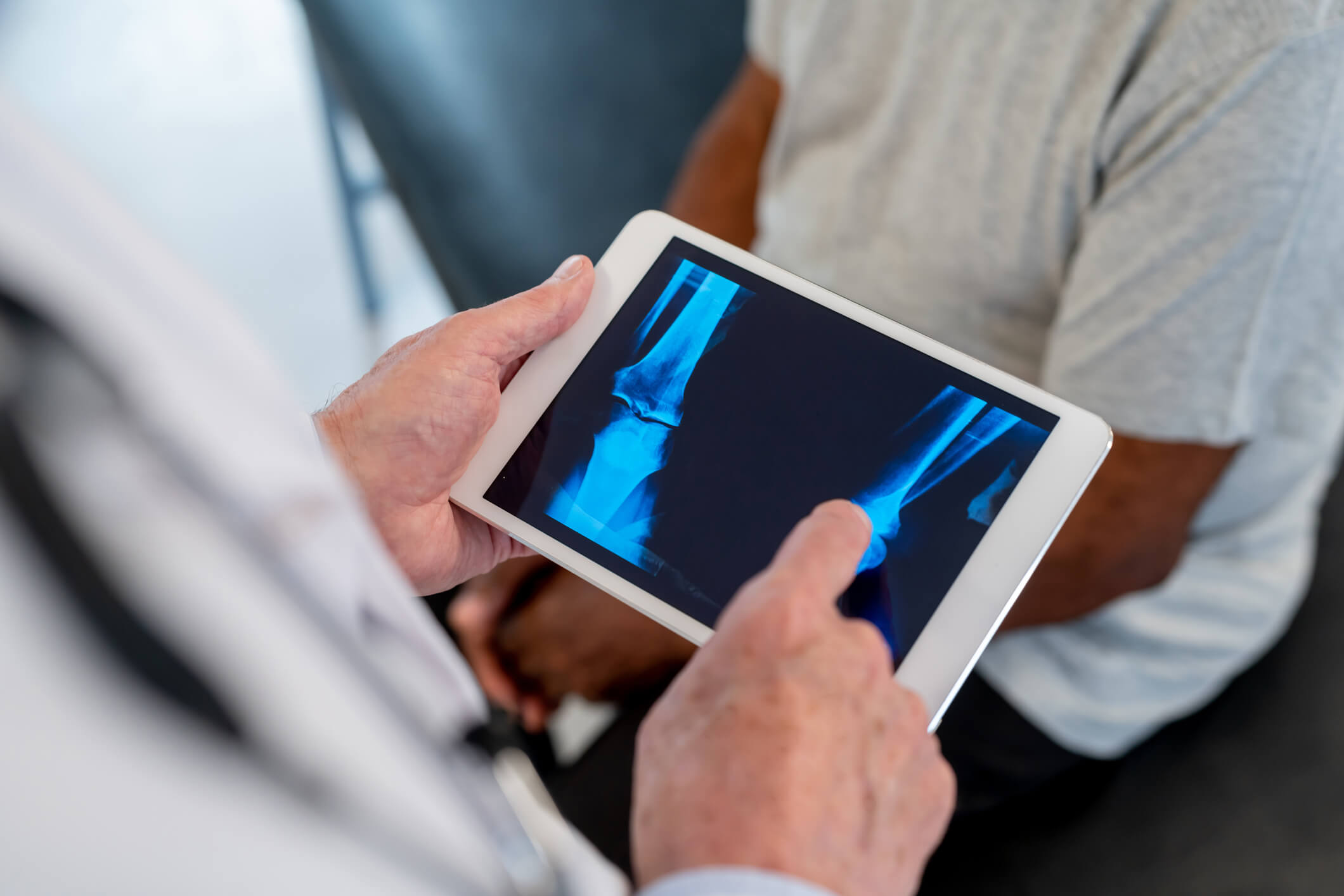 North Carolina workers compensation benefits covering medical care: doctor reviewing an X-ray with an injured worker