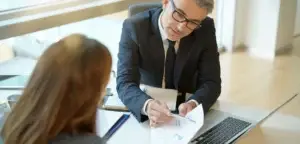Augusta personal injury lawyer reviewing an injured client's claim at a desk