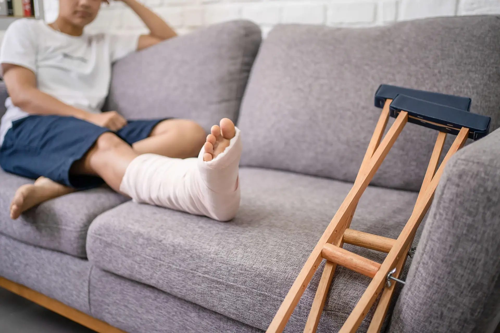 Macon personal injury lawyer for someone recovering at home with a leg cast and crutches after an accident