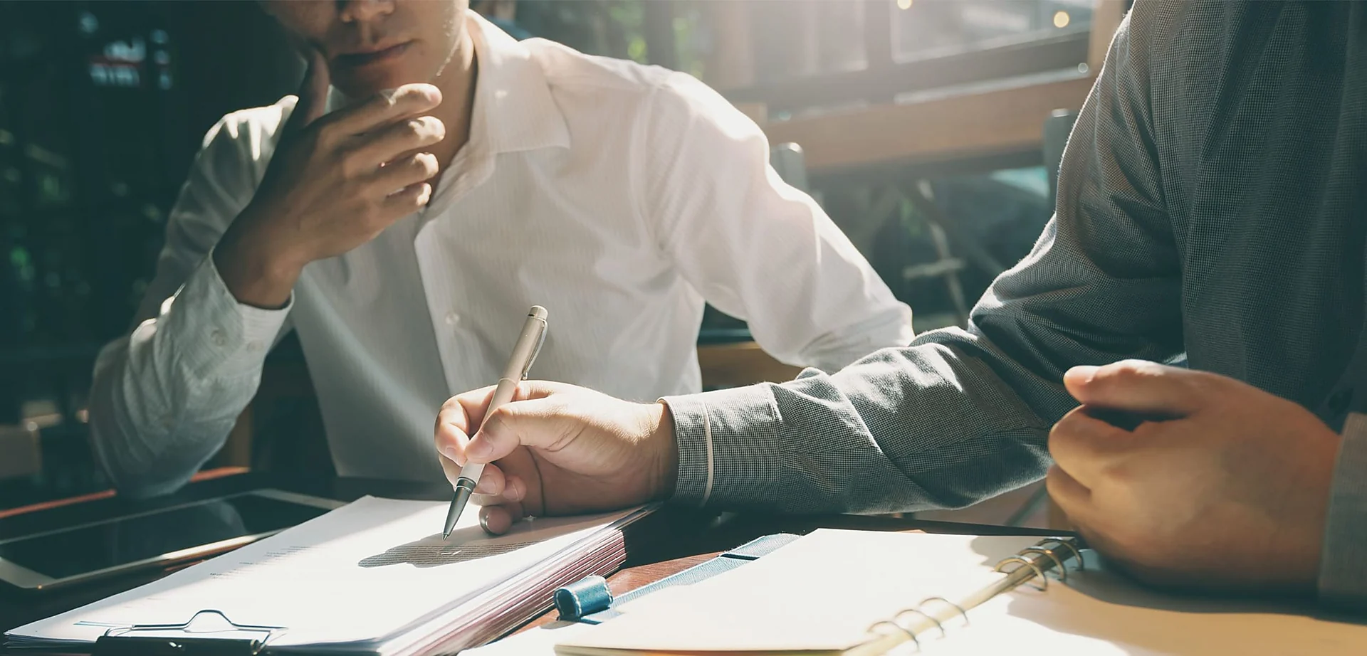 Gastonia personal injury lawyer going over a client's claim paperwork at a desk