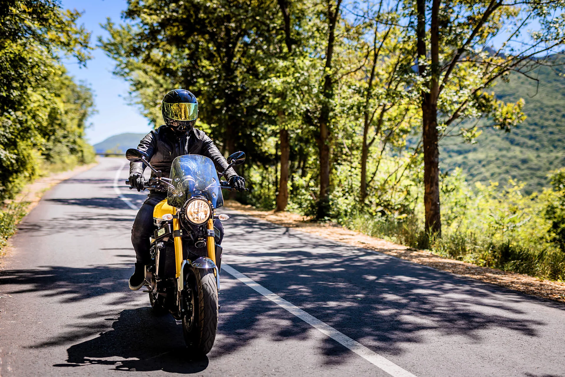Gastonia motorcycle accident lawyer for a rider in full safety gear on a two-lane road