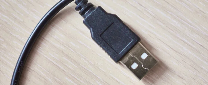 Broken usb cable on wooden table